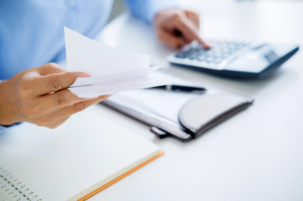 Woman with bills and calculator