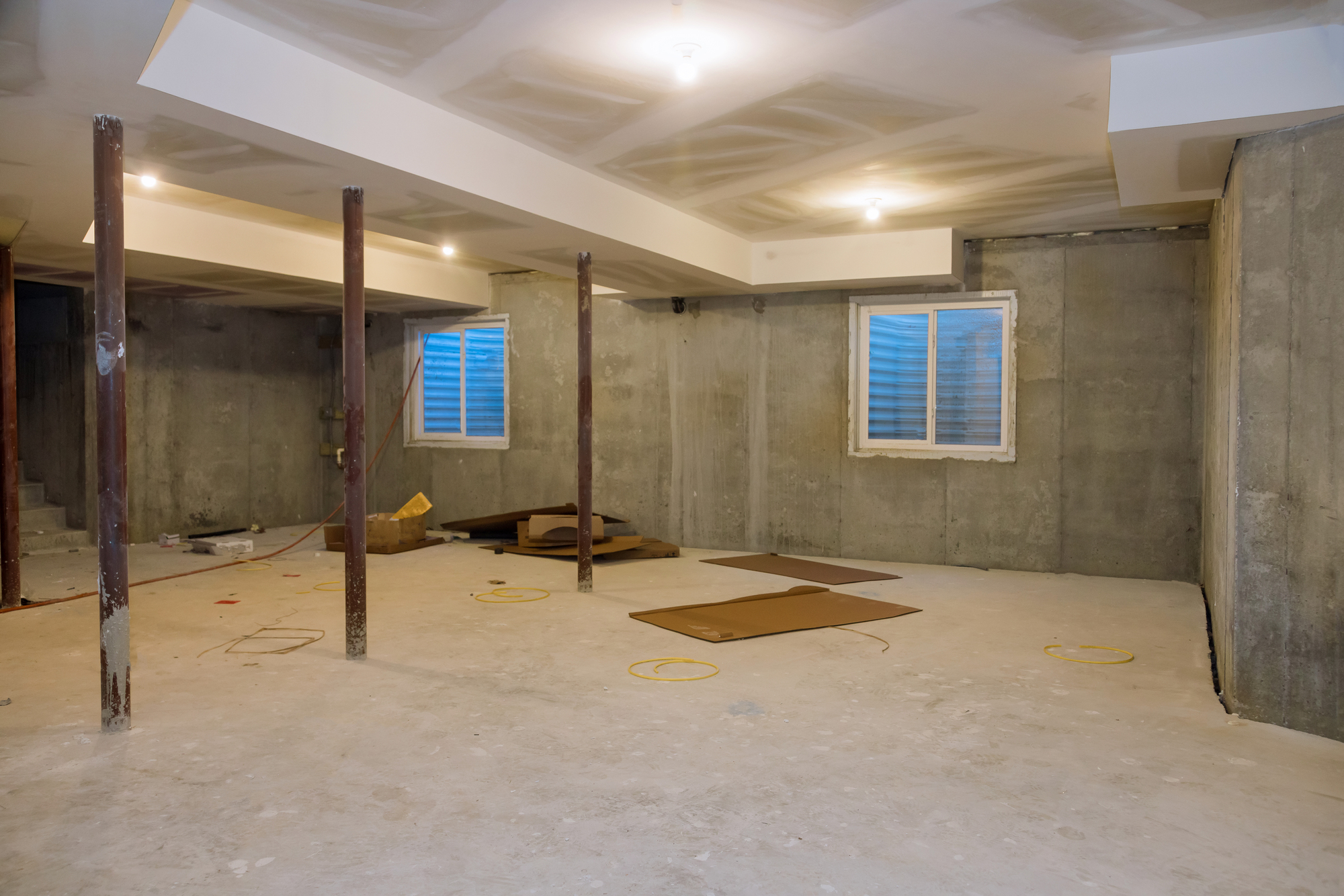 Empty under construction unfinished view on concrete floor construction of basement of home