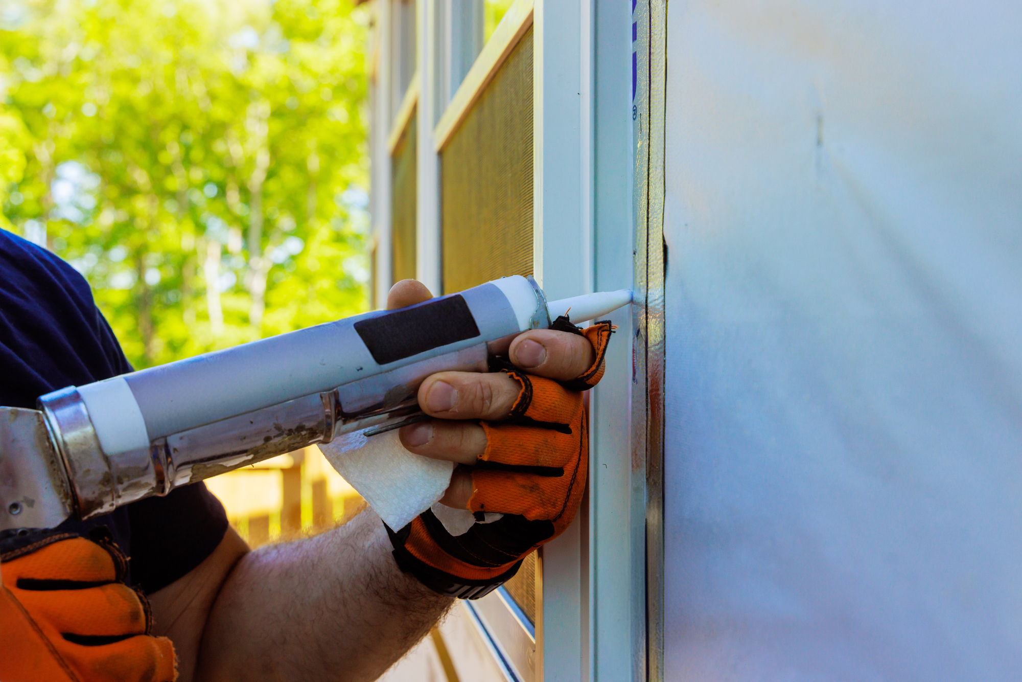 After windows have been installed, seams are coated with silicone, seals are stripped