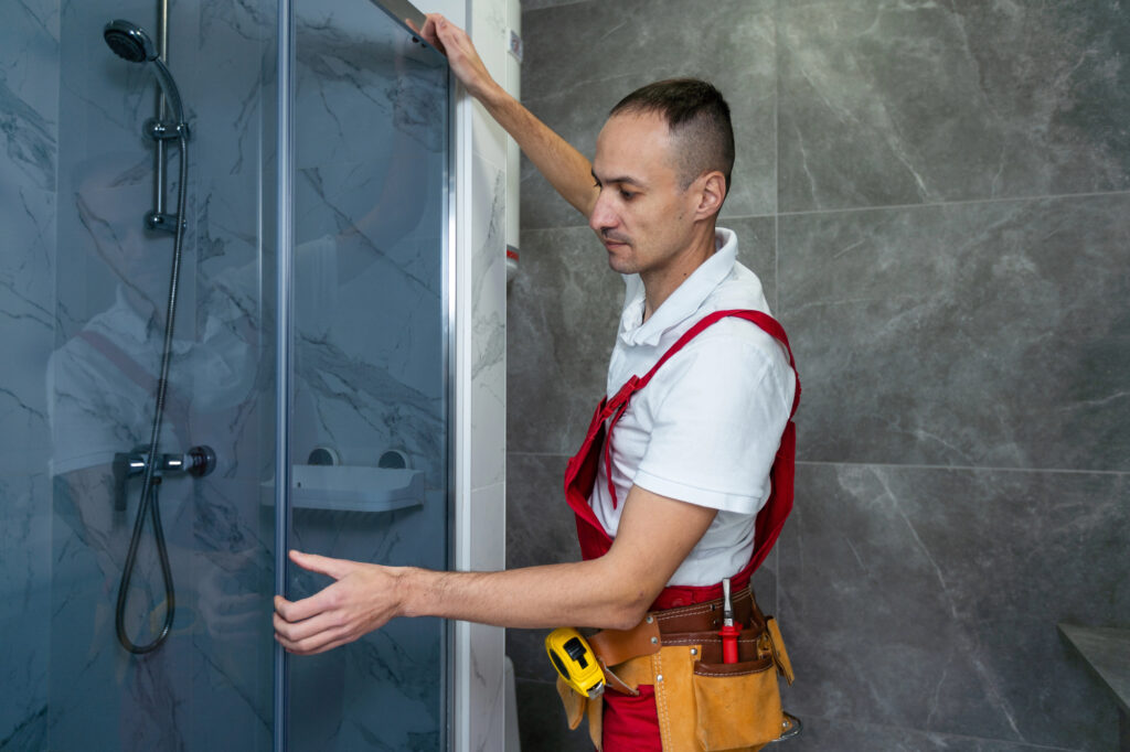 Worker measuring plastic window indoors